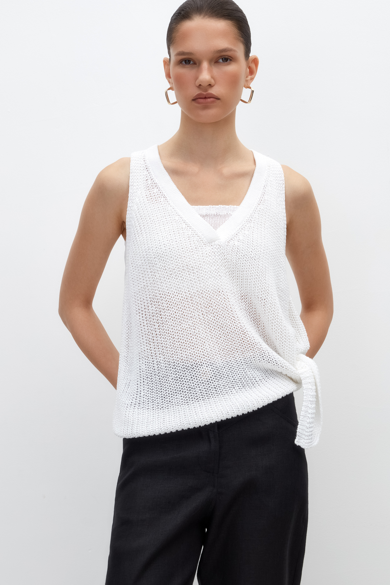 Трикотажный топ из 100% льна с V-образным вырезом. Модель асимметричного силуэта с глубокой проймой.