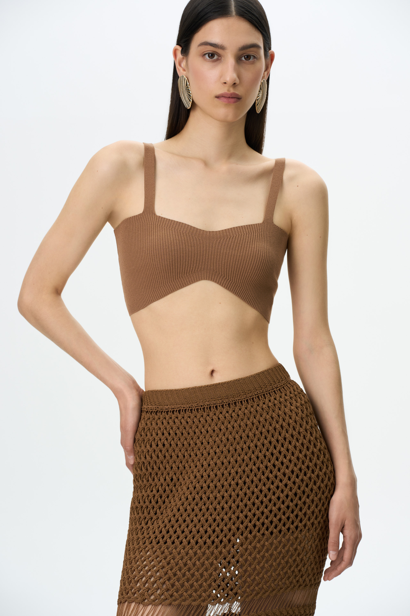 Трикотажный кроп-топ из вискозы. Модель на тонких бретелях. Изделие выполнено в рубчик.