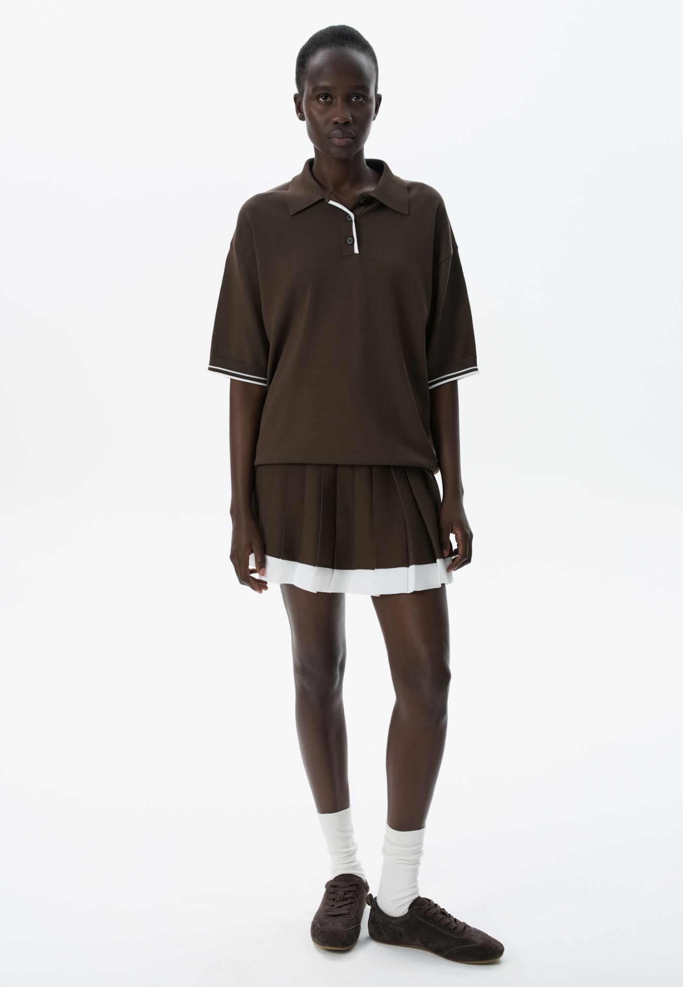 Трикотажная юбка плиссе длины мини из вискозы. Модель с широким эластичным поясом в рубчик. Пояс и нижняя часть юбки выполнены из пряжи контрастного цвета.