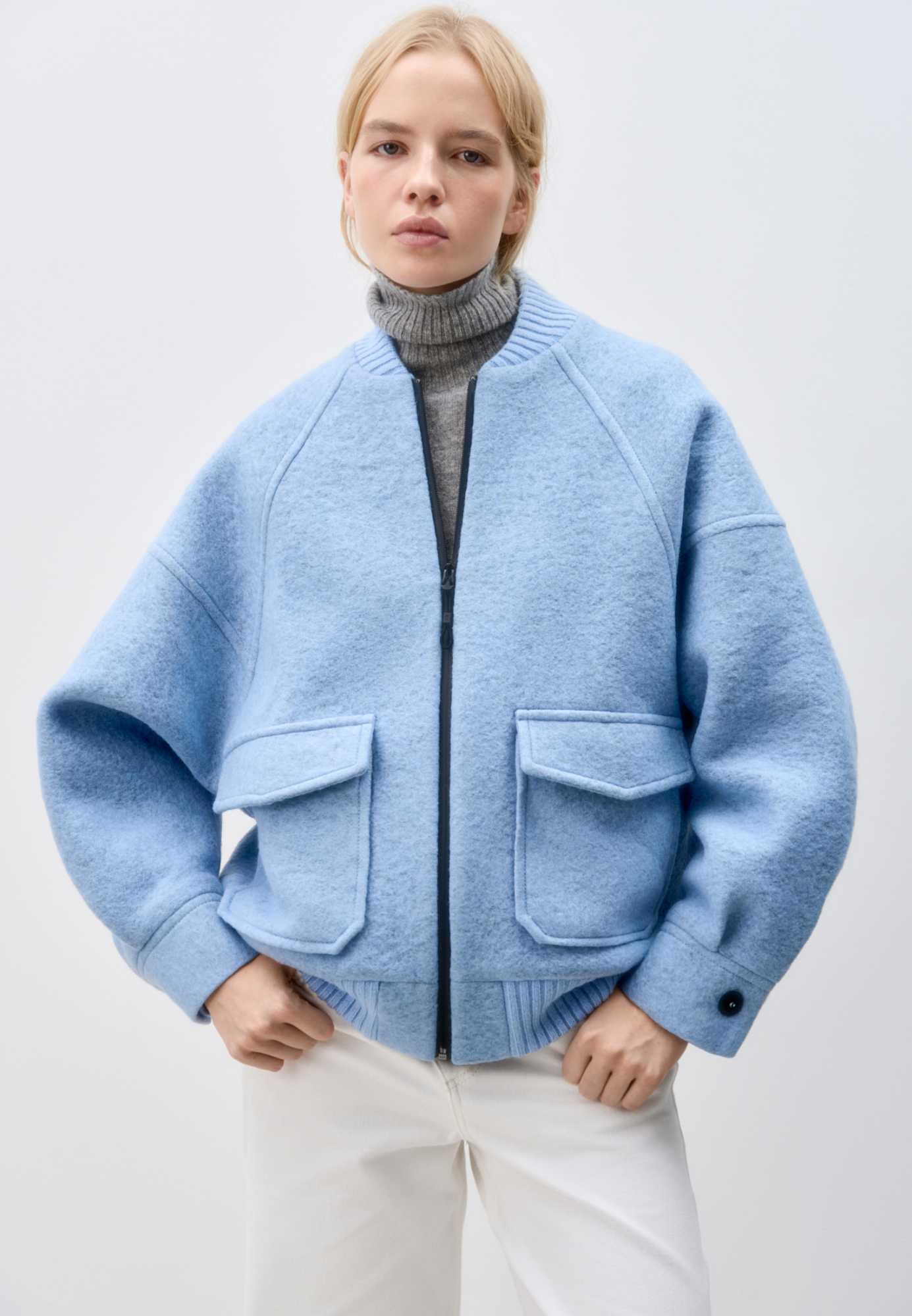 Свободный бомбер из валяной шерсти. Горловина и низ на резинке, манжеты застегиваются на пуговицы. Два передних кармана на клапанах. Застежка на молнию.