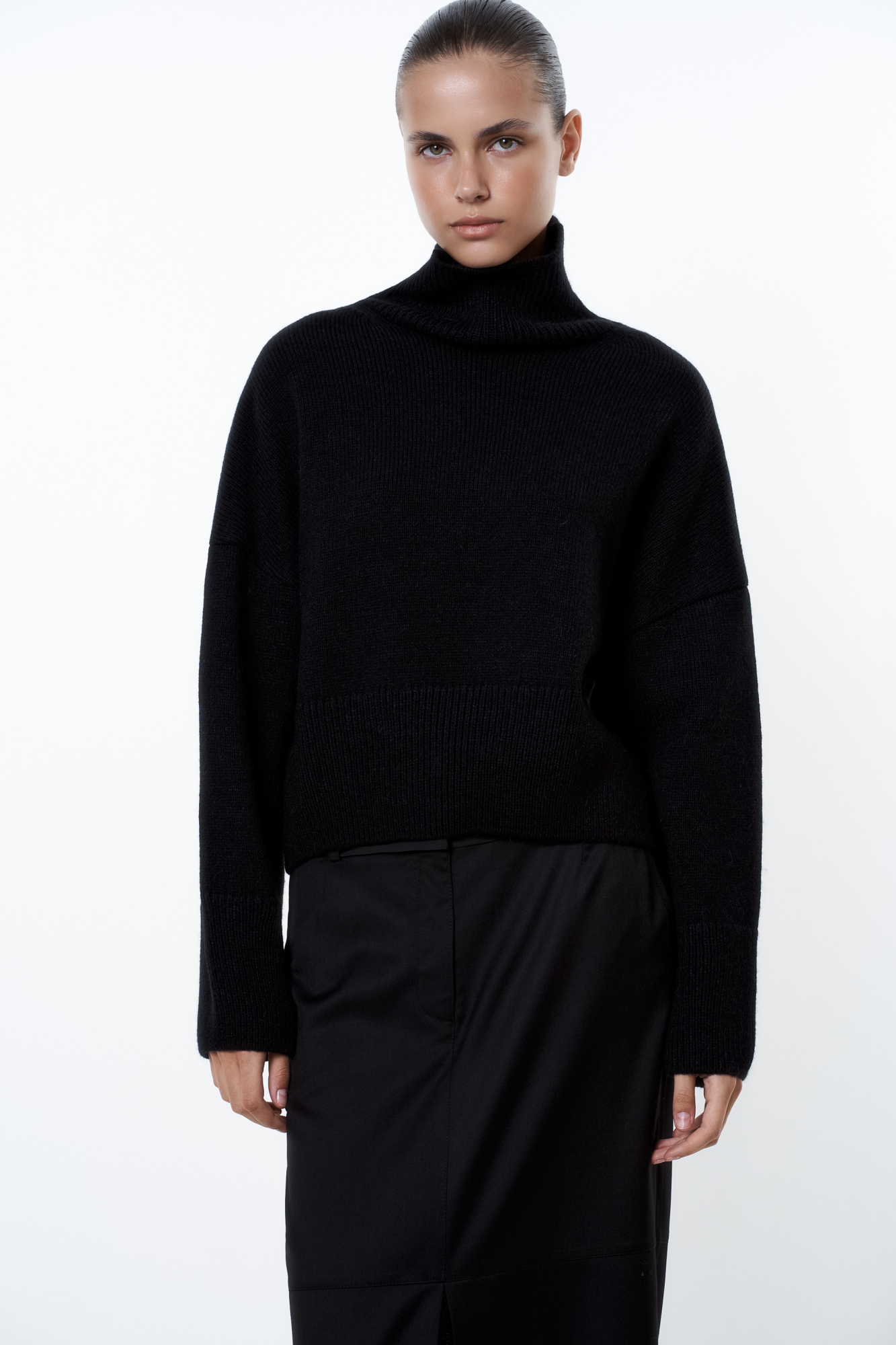 Трикотажный джемпер с шерстью альпака. Модель свободного силуэта с высоким воротником, спущенной линией плеча и длинными рукавами. Манжеты и низ изделия в рубчик.