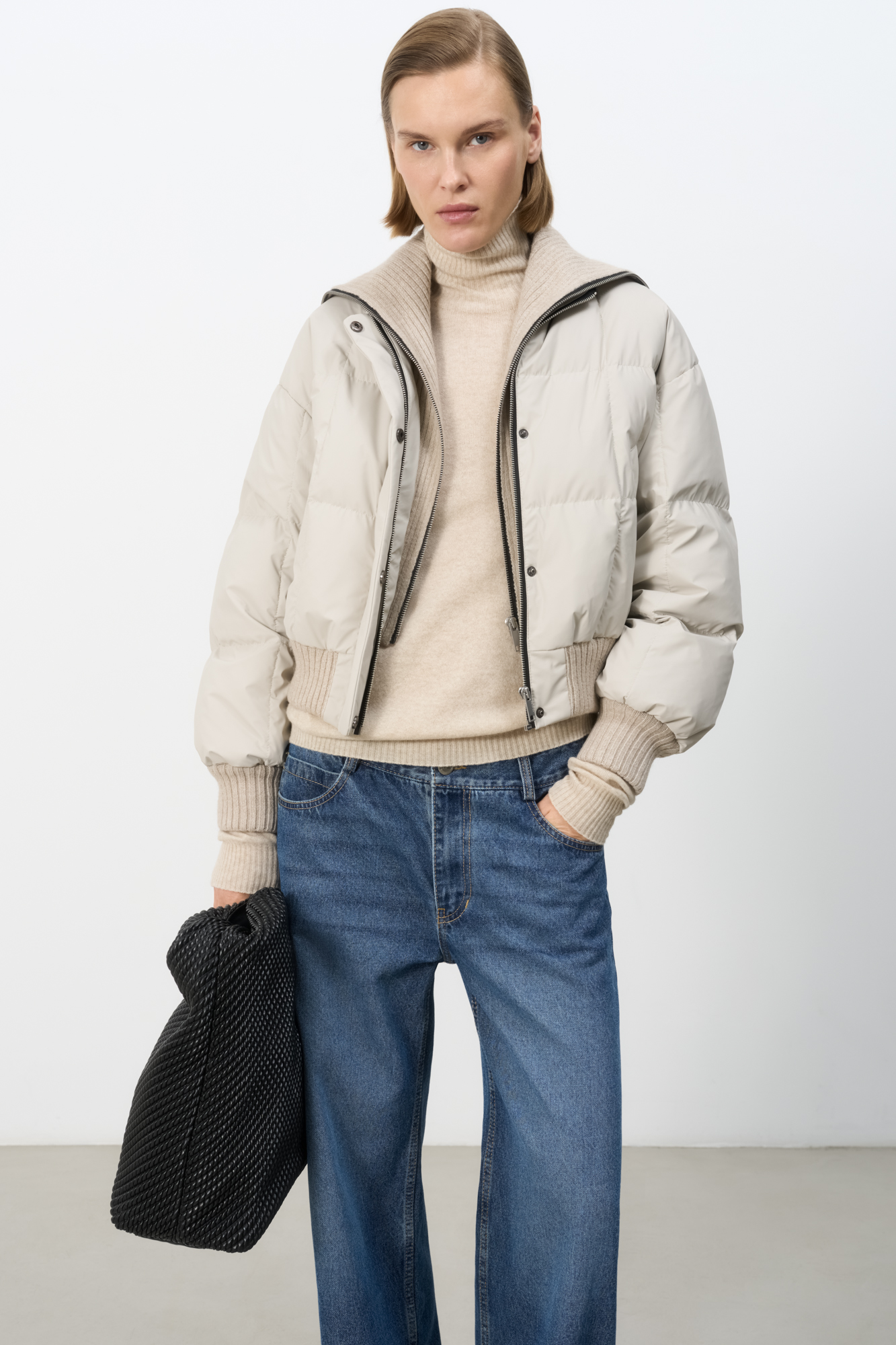 Стеганый короткий пуховик с высоким трикотажным воротником,&nbsp;&nbsp;манжетами и боковыми карманами. Застежка на молнии и кнопки под планкой. Низ изделия выполнен на широкой резинке. Брендированный логотип сзади. На подкладке. 