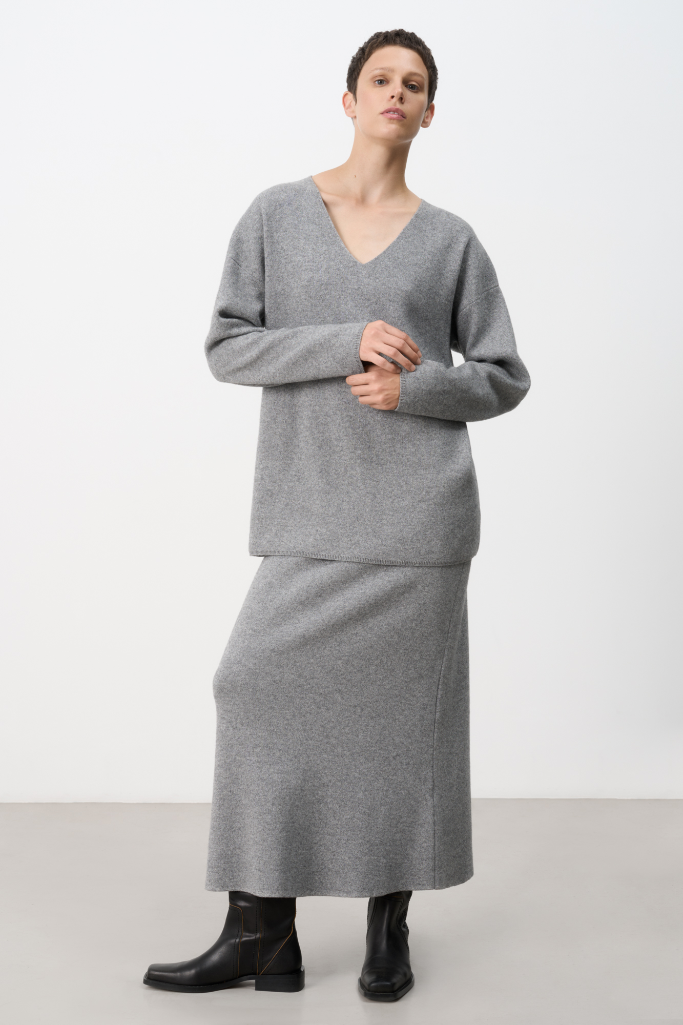 Трикотажная юбка длины миди, выполненная из смесовой шерсти с добавлением кашемира. Модель расклешенного силуэта, с широким эластичным поясом со шлевками и двумя накладными карманами сзади.