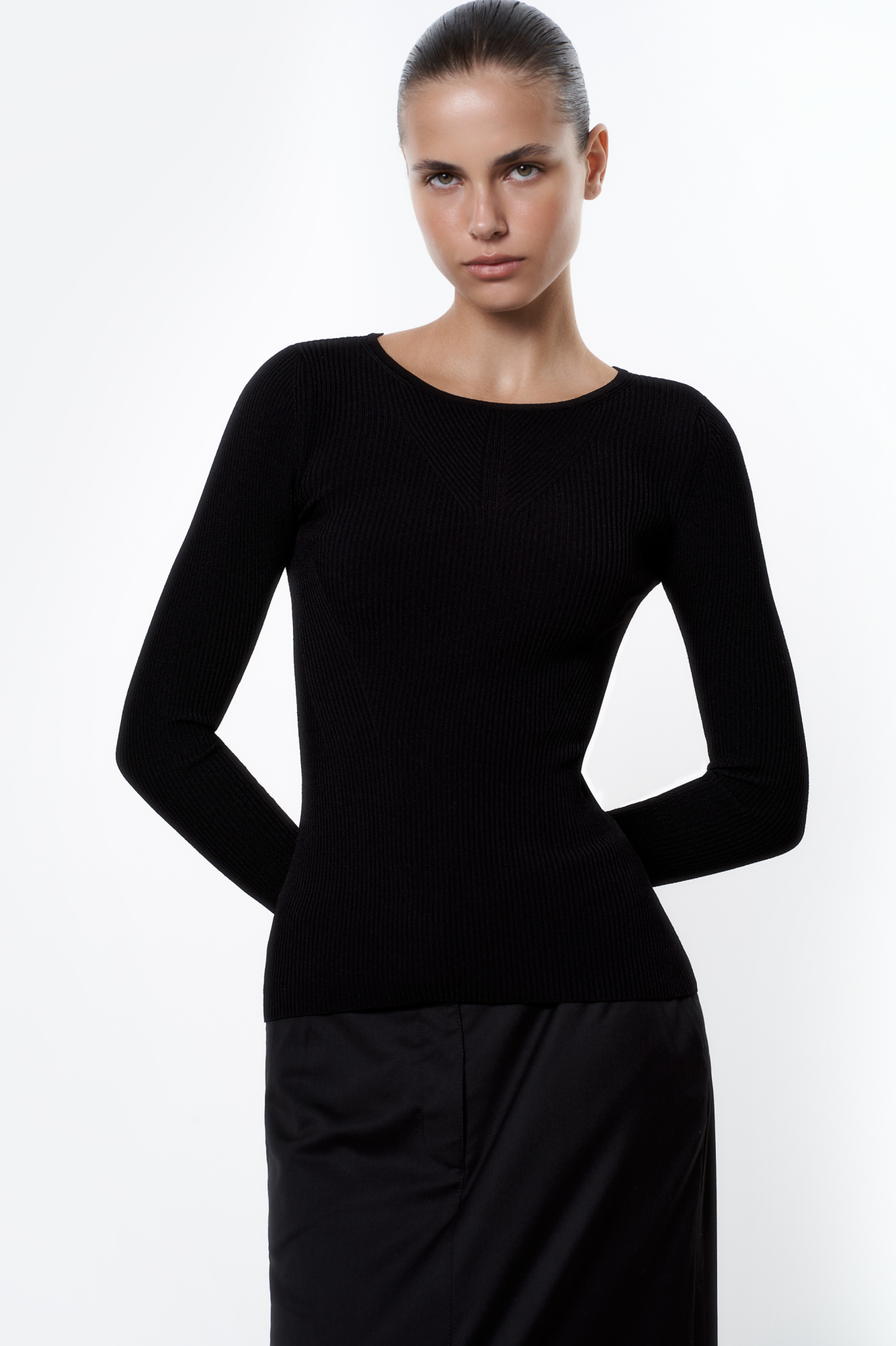 Трикотажный топ из тонкого трикотажа на основе вискозы. Модель с длинным рукавом и круглым вырезом горловины. Изделие декорировано вывязанным узором на груди и глубоким вырезом со шнуровкой на спине.