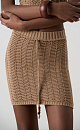 Трикотажная юбка длины мини из хлопка. Модель по фигуре, с эластичным поясом в рубчик, дополненным кулиской. Изделие выполнено узором "ёлочка".
