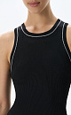 Трикотажный топ из вискозы в рубчик. Модель приталенного силуэта, без рукавов и круглым вырезом горловины. Изделие декорировано строчкой контрастного цвета.