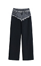 Широкие брюки из вискозы, со средней посадкой, декорированные вставкой из джинсовой ткани. Модель свободного силуэта с боковыми карманами и застежкой на молнию и пуговицу.