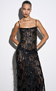 Платье длины макси с геометрическим орнаментом и бахромой, выполненными пайетками. Модель на тонких бретелях, без застежки. Изделие выполнено без подкладки.