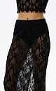 Юбка длины миди, выполненная из тонкого кружева. Модель прямого силуэта с разрезом сзади и застежкой на молнию. Изделие без подкладки. Дополнить образ можно лонгсливом в таком же стиле.