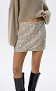 Юбка длины мини, расшитая пайетками и цветным бисером. Застежка на молнию сбоку. Изделие выполнено на подкладке.