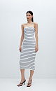 Трикотажное платье длины миди из вискозы в рубчик. Модель приталенного силуэта, на тонких бретельках и разрезом сзади.