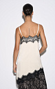 Платье-комбинация длины мини из 100% вискозы. Модель на тонких бретельках. Подол и лиф изделия декорированы тонким кружевом контрастного цвета.