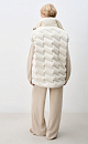 Объемный стеганый жилет на пуху. Модель прямого кроя, с воротником стойкой и боковыми карманами. Застежка на молнию и кнопки под планкой.