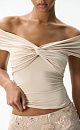 Топ из модала с открытой линией плеч. Модель приталенного силуэта, без рукавов. Изделие декорировано перекрутом на груди и драпировкой на лифе. 