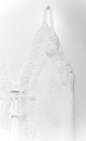 Трикотажный топ из вискозы с завязками на груди. Модель приталенного силуэта на тонких бретельках. Изделие декорировано кружевом.