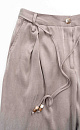 Брюки из купры. Модель свободного кроя, со шлевками на поясе для ремня, двумя боковыми карманами и карманом сзади.&nbsp;&nbsp;Застежка на молнию и пуговицу. Изделие декорировано тонким шнурком с бусинами. 
