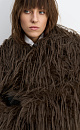 Шуба из экомеха с длинным ворсом. Модель с широким отложным воротником, шлевками для пояса из экокожи и врезными карманами. Изделие выполнено на подкладке.
