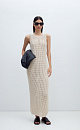 Трикотажный сарафан из хлопка с добавлением эластана, выполненный ажурной вязкой. Модель прямого силуэта, без рукавов, с глубокой проймой и круглым вырезом горловины.