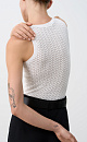 Трикотажный ажурный топ из вискозы с вывязанным орнаментом сердечками. Модель приталенного силуэта, с круглым вырезом горловины, без рукавов, на широких лямках. Края изделия выполнены в рубчик.