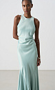Атласное платье длины макси. Модель приталенного силуэта, с круглым вырезом горловины, без рукавов. Модель декорирована асимметричной юбкой и драпировкой на талии.