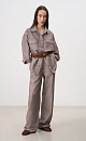 Брюки изо льна и хлопка. Модель прямого кроя с поясом на резинке и двумя боковыми карманами.