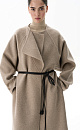 Шерстяное пальто из двусторонней ткани. Модель прямого кроя без воротника. Застежка на скрытые магнитные пуговицы. Изделие без подкладки. Модель декорирована асимметричным лацканом. Пояс из экокожи в комплекте.