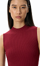 Трикотажное платье длины мини из вискозы. Модель по фигуре с каркасными воланами и невысоким воротником-стойкой.