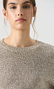 Трикотажный джемпер с голографическими пайетками. Модель свободного силуэта со спущенной линией плеча и круглой горловиной. Дополнить образ можно юбкой в таком же стиле. 
