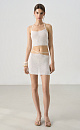 Трикотажная юбка длины мини из хлопка с добавлением вискозы. Изделие декорировано мелкими пайетками. Модель прямого кроя с акцентной деталью в виде тонкого пояса. Без подкладки.