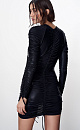 Платье длины мини из трикотажного полотна. Модель приталенного силуэта, с длинными рукавами и кулисками на рукавах и бедрах. Изделие декорировано драпировкой.