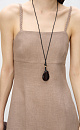 Сарафан длины миди из 100% льна. Модель приталенного силуэта, на тонких бретельках в виде косичек и высоким разрезом сбоку. Спинка изделия выполнена на резинке.