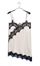 Платье-комбинация длины мини из 100% вискозы. Модель на тонких бретельках. Подол и лиф изделия декорированы тонким кружевом контрастного цвета.