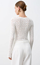 Трикотажный топ из органического хлопка. Модель с длинными рукавами и шнуровкой спереди. <br />
Изделие декорировано жаккардовым рисунком, имитирующим пятна леопарда. <br />
Органический хлопок - более экологичная и безопасная альтернатива обычному хлопку, выращенная без использования химикатов.