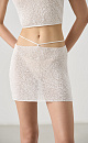 Трикотажная юбка длины мини из хлопка с добавлением вискозы. Изделие декорировано мелкими пайетками. Модель прямого кроя с акцентной деталью в виде тонкого пояса. Без подкладки.