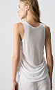 Трикотажная майка из вискозы. Модель свободного силуэта, без рукавов, на широких бретельках, с U-вырезом горловины и глубокой проймой. Кулиски по бокам изделия позволяют регулировать длину и создавать драпировку.
