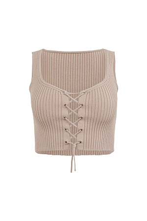 бежевый Короткий трикотажный топ из вискозы. Модель приталенного силуэта, без рукавов, на широких бретельках, с люверсами и шнуровкой на груди. Дополнить образ можно юбкой в таком же стиле.